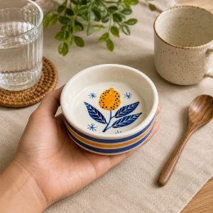 The Plush Republic Hand-Painted Orange Flower Ceramic Bowl – Blue Leaves & Stripe Rim